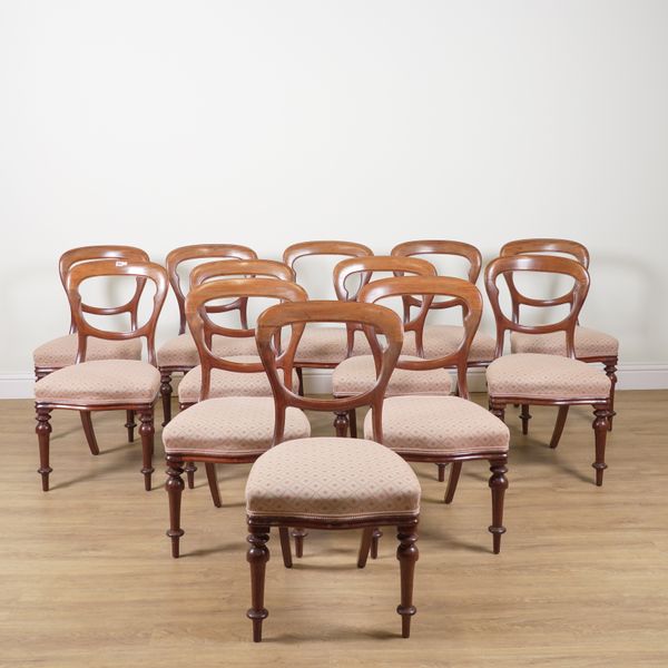 A SET OF TWELVE VICTORIAN MAHOGANY BALLOON BACK DINING CHAIRS (12)