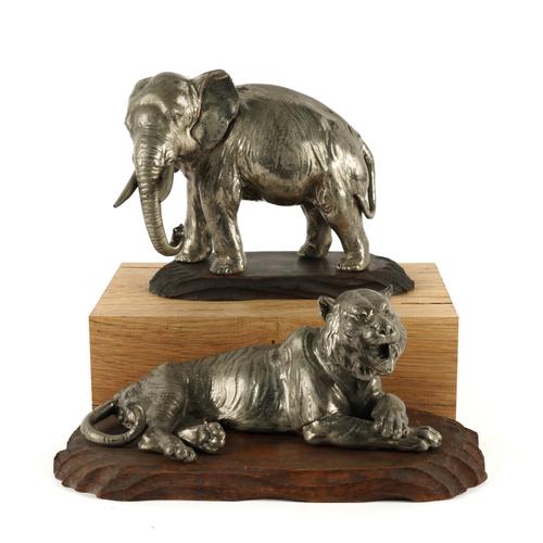 AN ASIAN WHITE METAL MODEL OF AN ELEPHANT AND A SIMILAR TIGER (2)