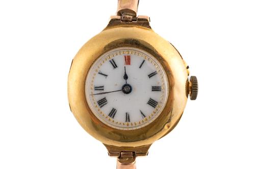 A GOLD CIRCULAR CASED LADY'S WRISTWATCH