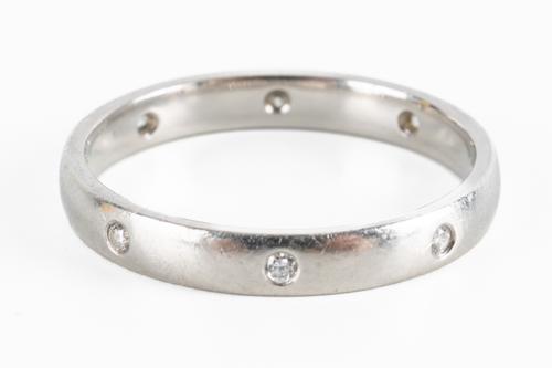 A PLATINUM AND DIAMOND WEDDING RING