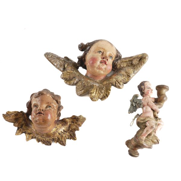 TWO SOUTH GERMAN/ AUSTRIAN 'BAROQUE' POLYCHROME AND GILT-WOOD CHERUB HEADS (3)