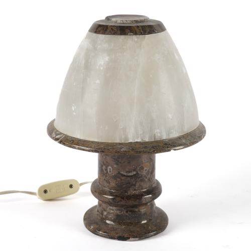 A TURNED AND POLISHED FOSSIL LAMP WITH DOMED CALCITE SHADE
