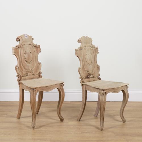 A PAIR OF VICTORIAN BLEACHED OAK CARTOUCHE BACK HALL CHAIRS (2)