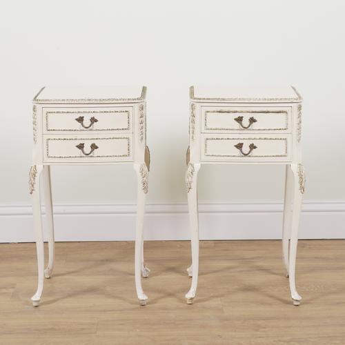 A PAIR OF MID 20TH CENTURY CREAM AND PARCEL GILT PAINTED TWO DRAWER BEDSIDE TABLES (2)