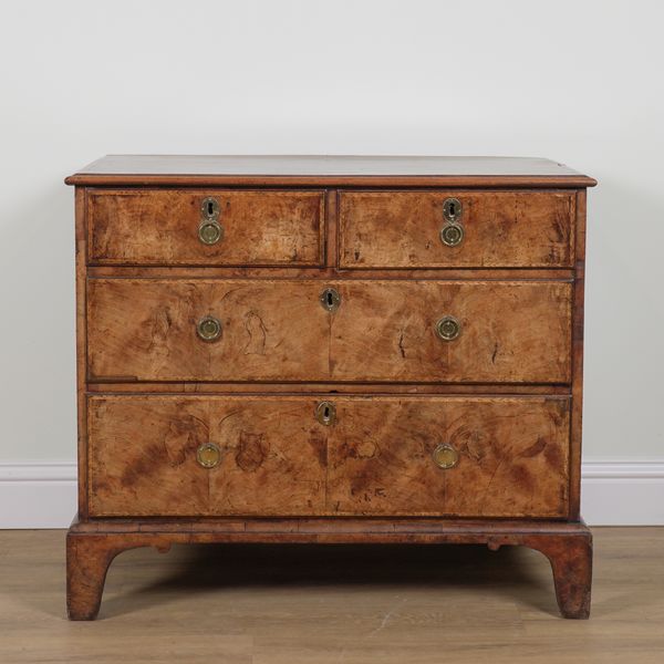 A GEORGE III FIGURED WALNUT FOUR DRAWER CHEST