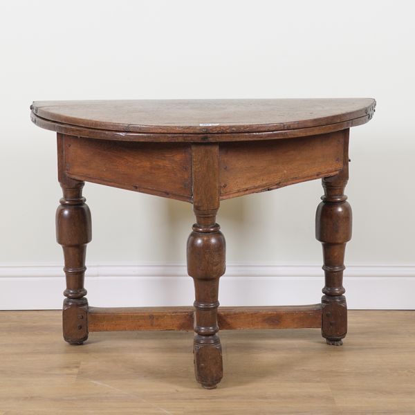 A 17TH CENTURY OAK SEMI ELLIPTIC FOLD OVER CREDENCE TABLE