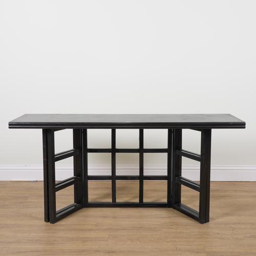 IN THE MANNER OF CHARLES RENNIE MACKINTOSH; AN EBONISED ASH FOLDOVER DINING TABLE