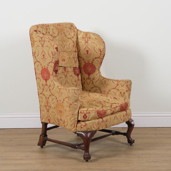 AN EARLY 18TH CENTURY WALNUT FRAMED WING BACK ARMCHAIR