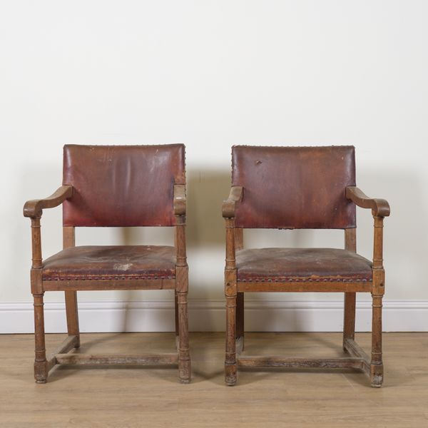 POSSIBLY HEALS; A PAIR OF EARLY 20TH CENTURY OAK FRAMED OPEN ARMCHAIRS (2)