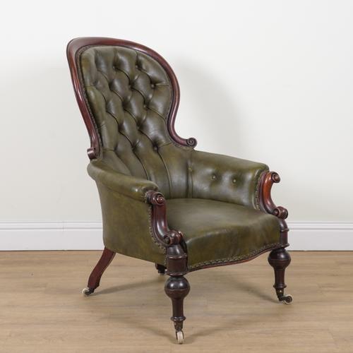 AN EARLY VICTORIAN MAHOGANY FRAMED GREEN LEATHER UPHOLSTERED SPOON BACK EASY ARMCHAIR
