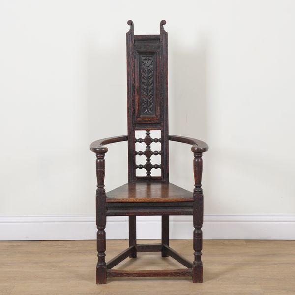 AN ARTS AND CRAFTS OAK FRAMED HIGHBACK OPEN ARMCHAIR
