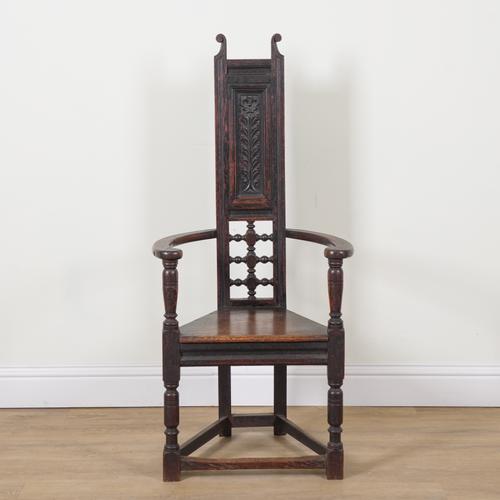 AN ARTS AND CRAFTS OAK FRAMED HIGHBACK OPEN ARMCHAIR
