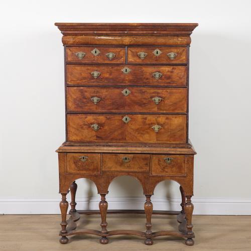 AN EARLY 18TH CENTURY FIGURED WALNUT CHEST ON STAND