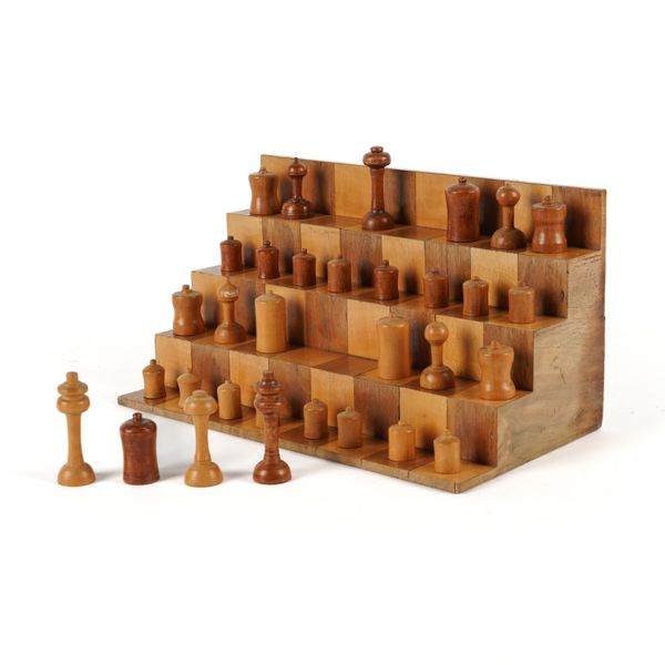 AN ABSTRACT TURNED FRUITWOOD CHESS SET AND STAND (33)