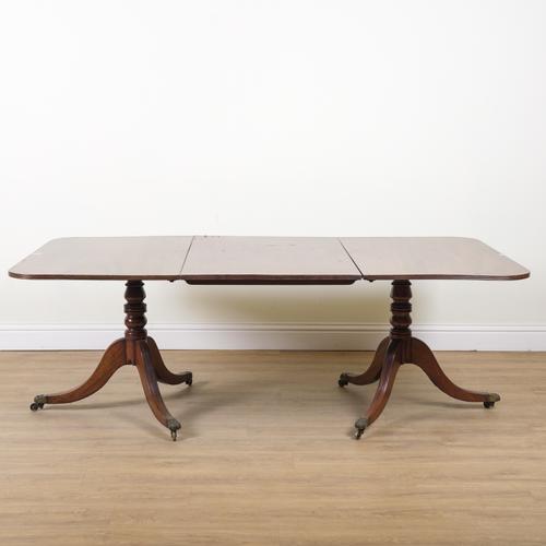 A GEORGE III STYLE MAHOGANY TWIN PILLAR DINING TABLE