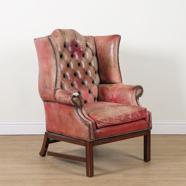 A GEORGE I STYLE STUDDED ROUGE LEATHER UPHOLSTERED WINGBACK ARMCHAIR