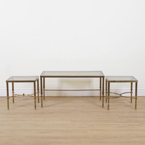 A NEST OF THREE MID 20TH CENTURY LACQUERED BRASS AND SMOKED GLASS OCCASIONAL TABLES