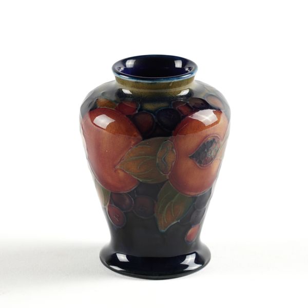 A SMALL MOORCROFT BALUSTER VASE