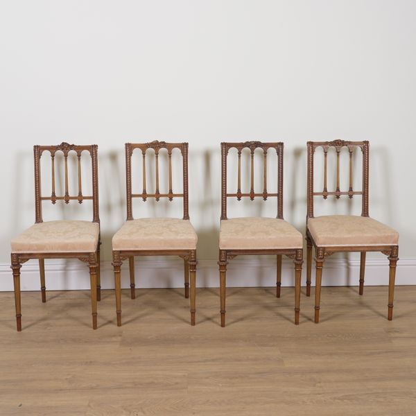 A SET OF FOUR FRENCH NEO CLASSICAL PARCEL GILT WALNUT SIDE CHAIRS (4)