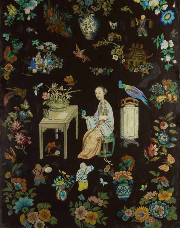 A CHINIOSERIE DECOUPAGE PANEL UNDER GLASS DECPICTING A SEATED LADY AT HER DESK