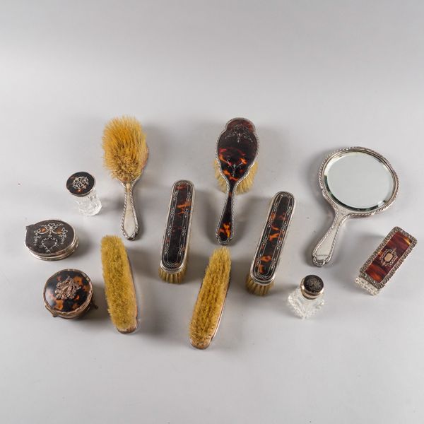 A GROUP OF SILVER AND TORTOISESHELL MOUNTED DRESSING TABLE WARES (12)