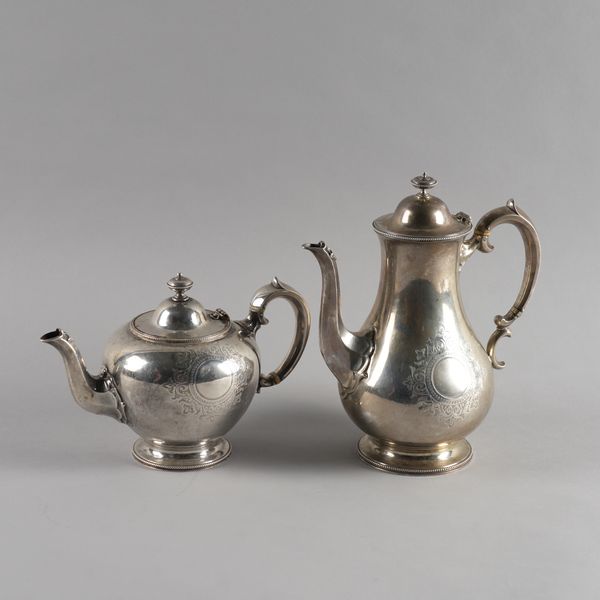 A VICTORIAN SILVER COFFEE POT AND A MATCHING SILVER TEAPOT (2)