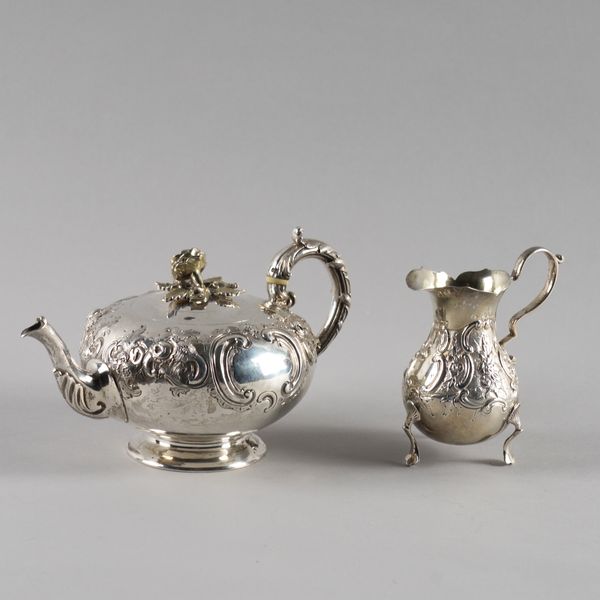 A VICTORIAN SILVER TEAPOT AND A VICTORIAN SILVER CREAM JUG (2)