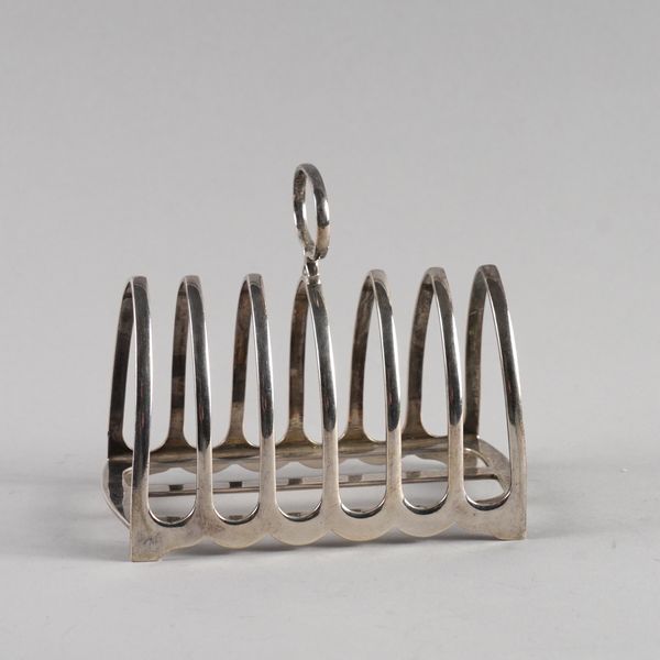 A SILVER SEVEN BAR TOASTRACK