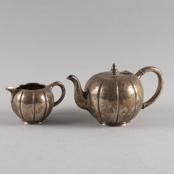 A VICTORIAN BATCHELOR'S SILVER TEAPOT WITH A MATCHING MILK JUG (2)