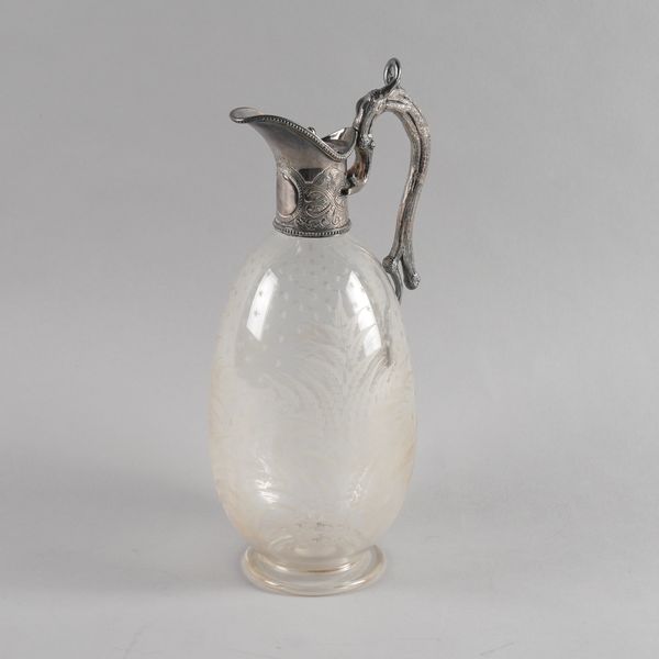 A LATE VICTORIAN SILVER PLATED METAL MOUNTED GLASS CLARET JUG