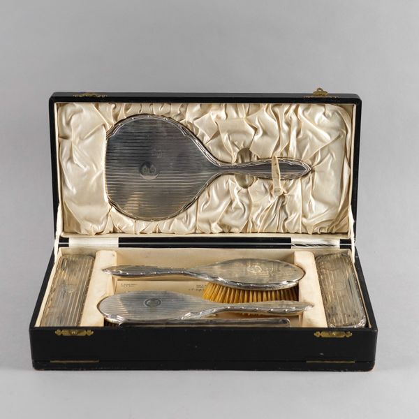 A SILVER MOUNTED SIX PIECE DRESSING SET