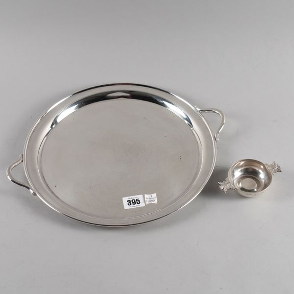 A PLATED TWIN HANDLED CIRCULAR TRAY AND A SCOTTISH SILVER TWIN HANDLED QUAICHE (2)