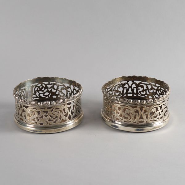 A PAIR OF VICTORIAN SILVER MOUNTED BOTTLE COASTERS (2)