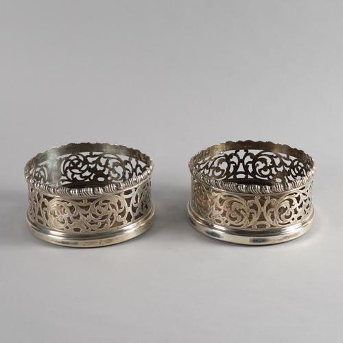 A PAIR OF VICTORIAN SILVER MOUNTED BOTTLE COASTERS (2)