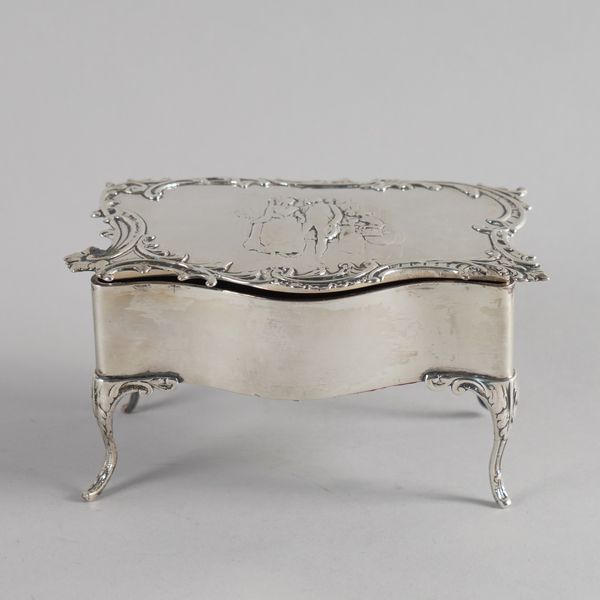 A SILVER SHAPED RECTANGULAR DRESSING TABLE BOX