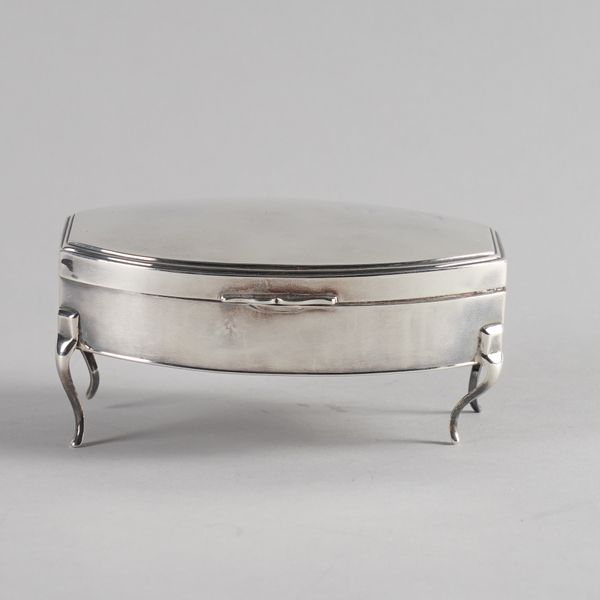 A SILVER SHAPED OVAL DRESSING TABLE BOX