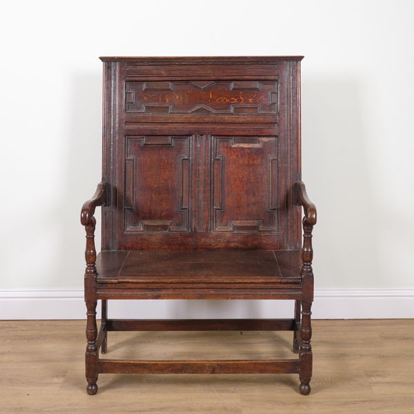 A CHARLES II STYLE OAK OPEN ARM SETTLE