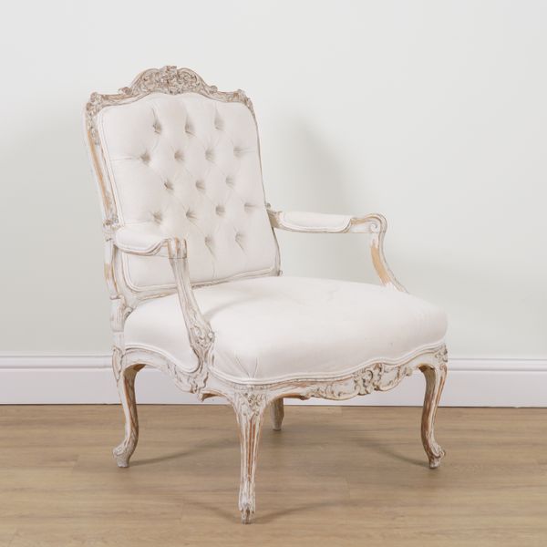 A LOUIS XVI STYLE CARVED AND WHITE WASHED BEECH FRAMED OPEN ARMCHAIR