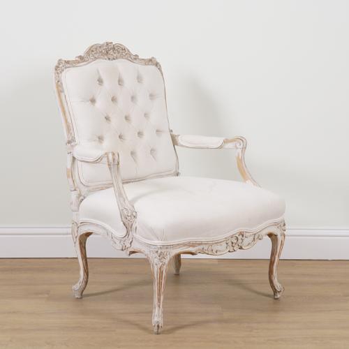 A LOUIS XVI STYLE CARVED AND WHITE WASHED BEECH FRAMED OPEN ARMCHAIR