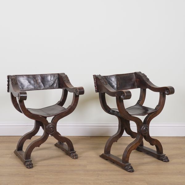 A PAIR 19TH CENTURY ITALIAN CARVED WALNUT FRAMED SAVONAROLA FOLDING ARMCHAIRS (2)