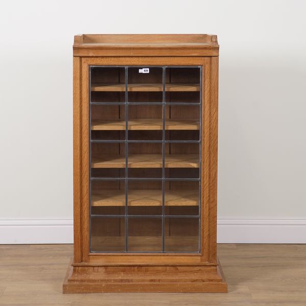 ROBERT MOUSEMAN THOMPSON OF KILBURN; A FLOORSTANDING OAK DISPLAY CABINET