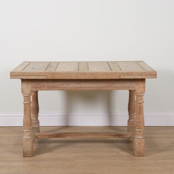 PROBABLY HEALS; AN OAK DRAW LEAF EXTENDING DINING TABLE