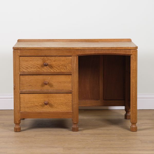 ROBERT MOUSEMAN THOMPSON OF KILBURN; AN OAK ADZED TOPPED KNEEHOLE WRITING DESK