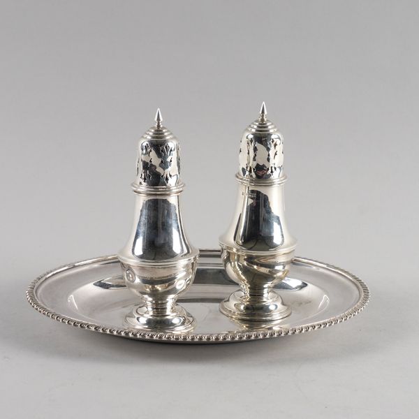 A PAIR OF SILVER SUGAR CASTERS AND A PLATED OVAL DISH (3)