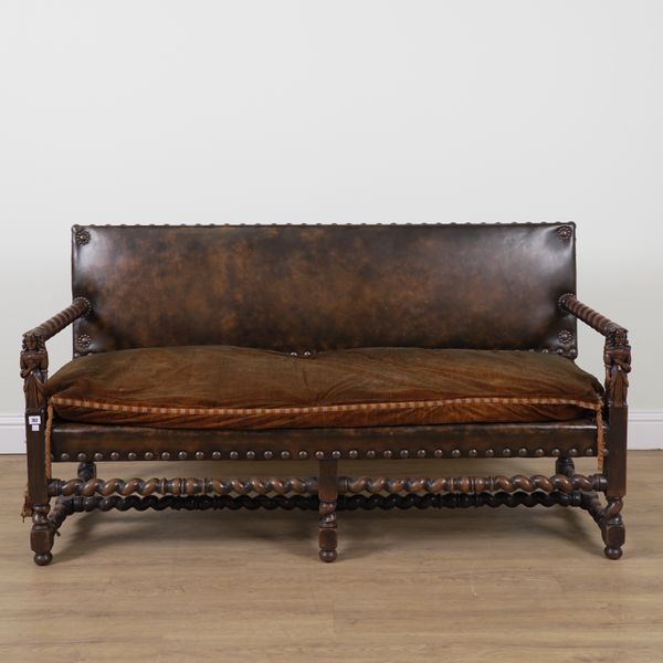 A LATE 19TH CENTURY CONTINENTAL STUDDED LEATHER UPHOLSTERED WALNUT FRAMED OPENARM BENCH