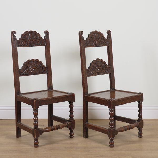 A PAIR OF CHARLES II STYLE CARVED OAK ARCH BACK SIDE CHAIRS (2)