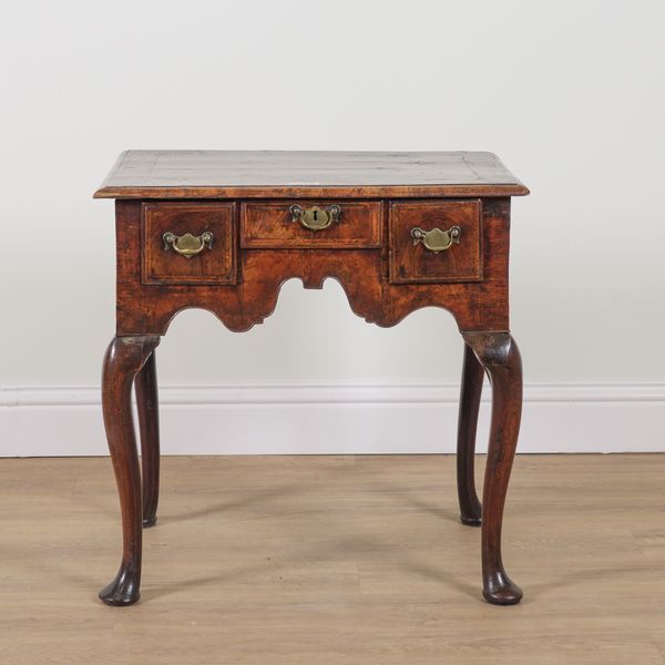 A MID-18TH CENTURY FEATHER BANDED WALNUT LOWBOY