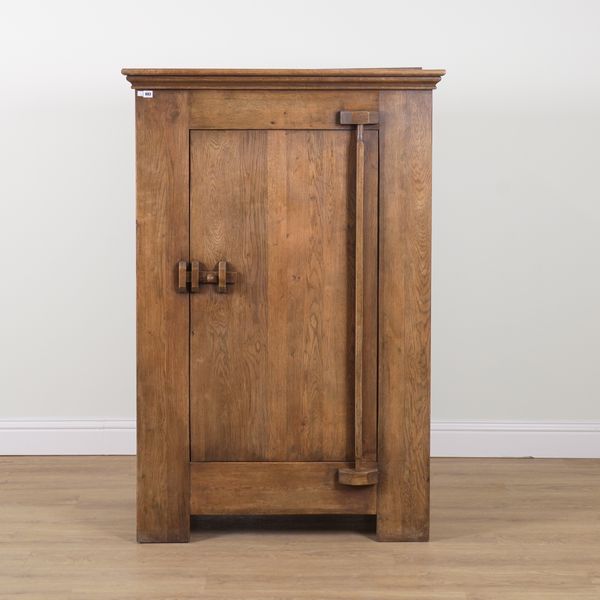 A CONTINENTAL STAINED OAK SINGLE DOOR CUPBOARD