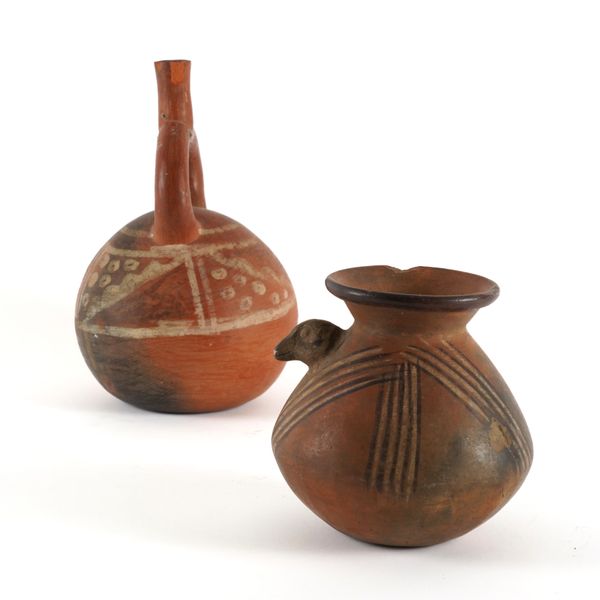 A PERUVIAN TERRACOTTA RED STIRRUP FLASK (2)