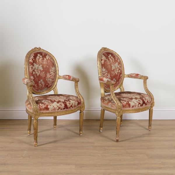 A PAIR OF LOUIS XVI STYLE GILT FRAMED OPEN ARMCHAIRS (2)